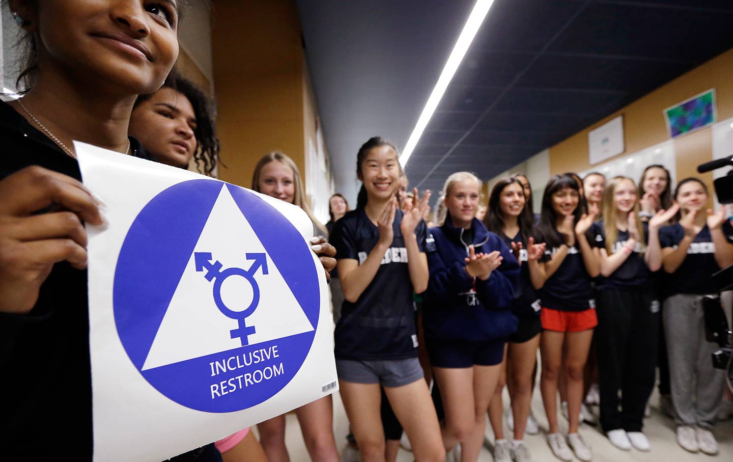 Students celebrate a gender-neutral bathroom