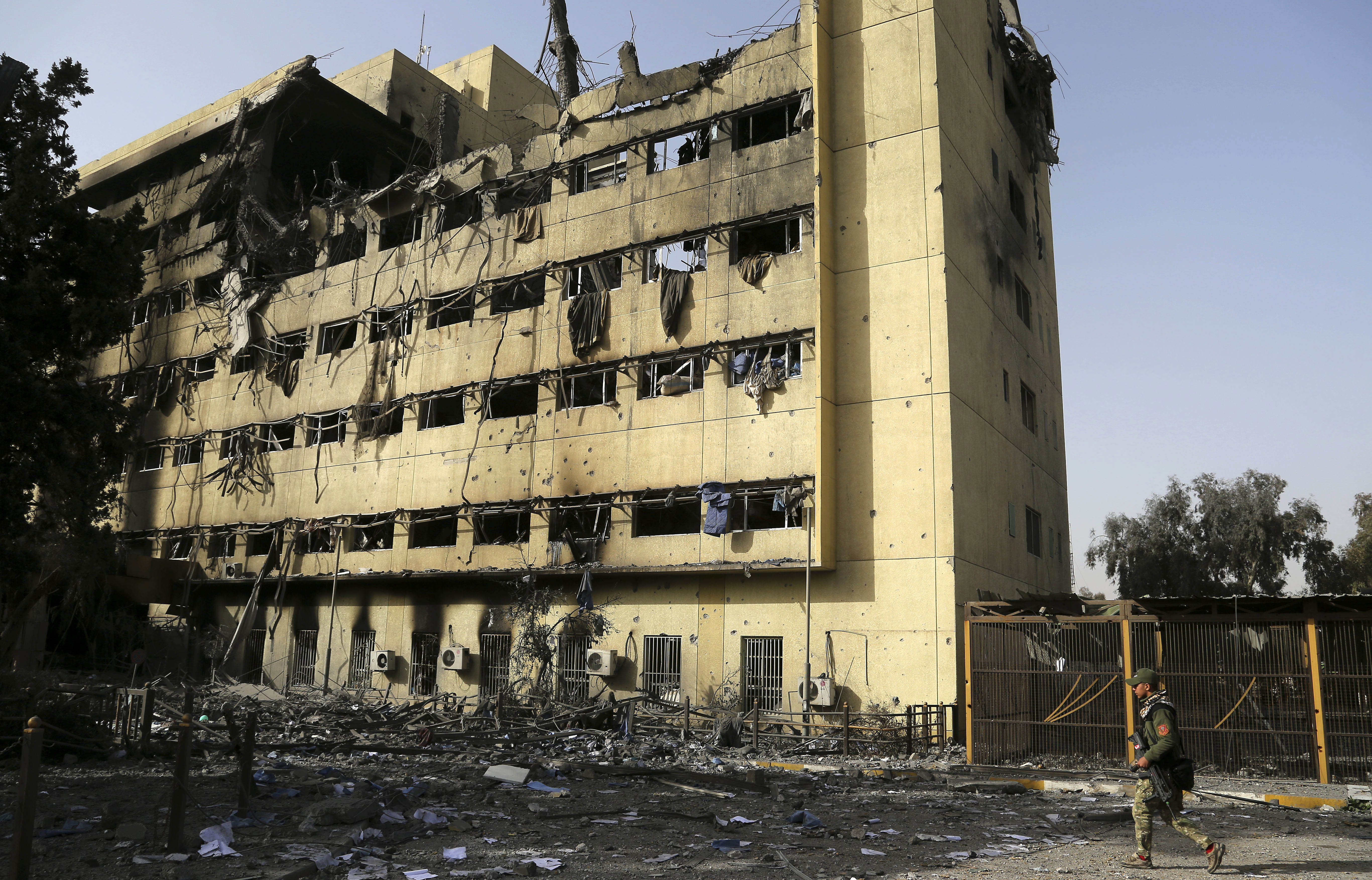 Iraqi Soldier by Gutted Iraqi Hospital