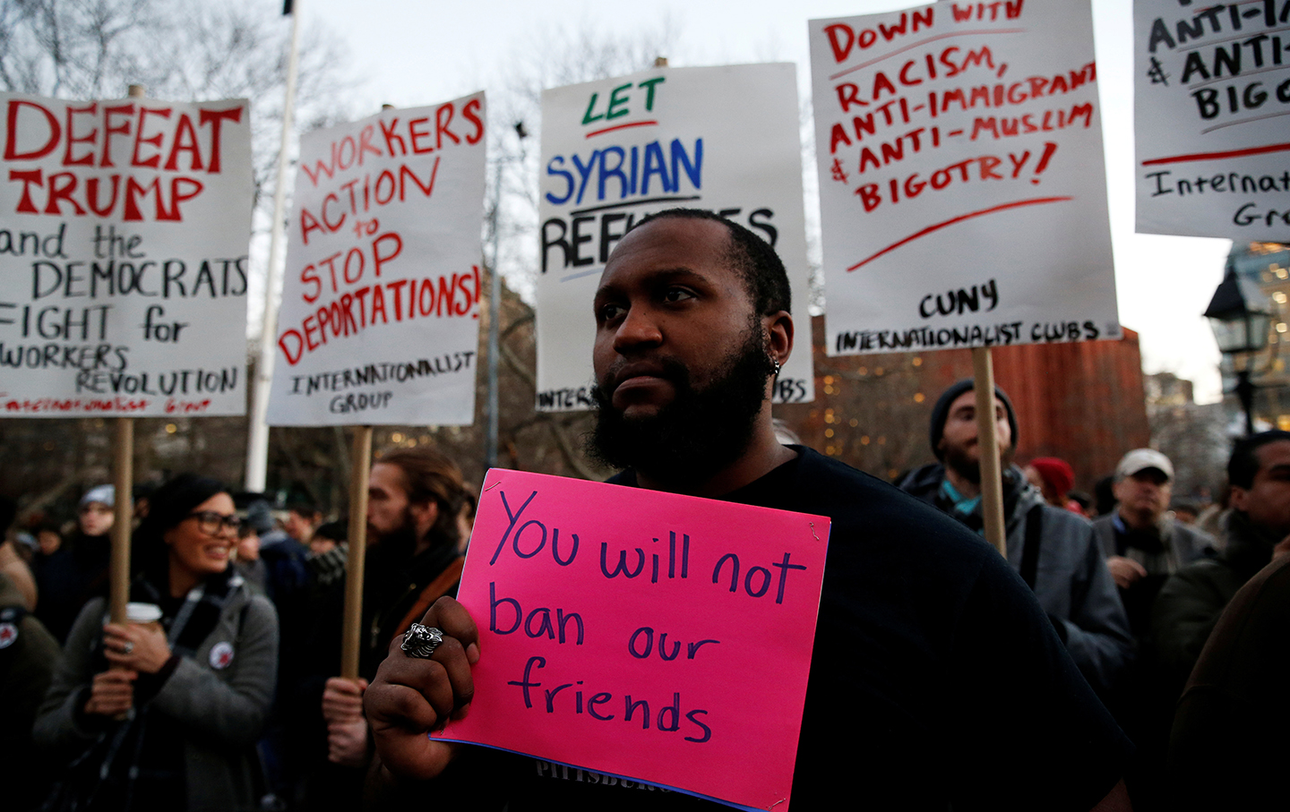 Isaiah Dupree holds a sign as demonstrators gather at Washington Square Park