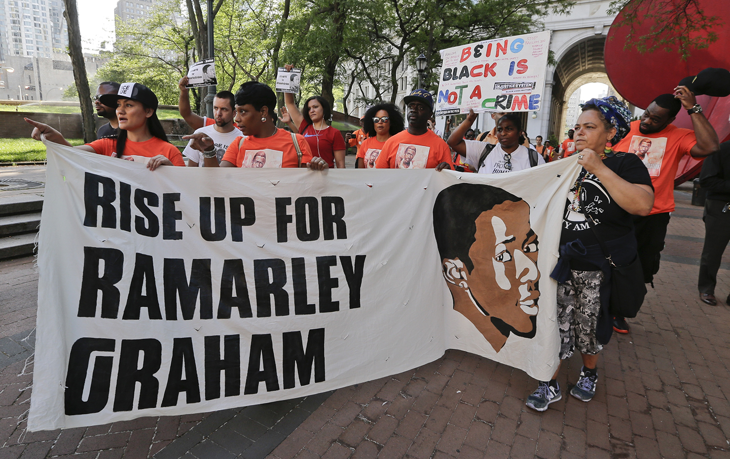 Protestors arrive at One Police Plaza in support of the family of Ramarley Graham Thursday, June 2, 2016, in New York. The mother of Graham, an unarmed black teenager fatally shot by a white policeman in front of his grandmother and young brother joined supporters Thursday for a 17-mile march to police headquarters to demand that the officers involved in the 2012 slaying be fired.