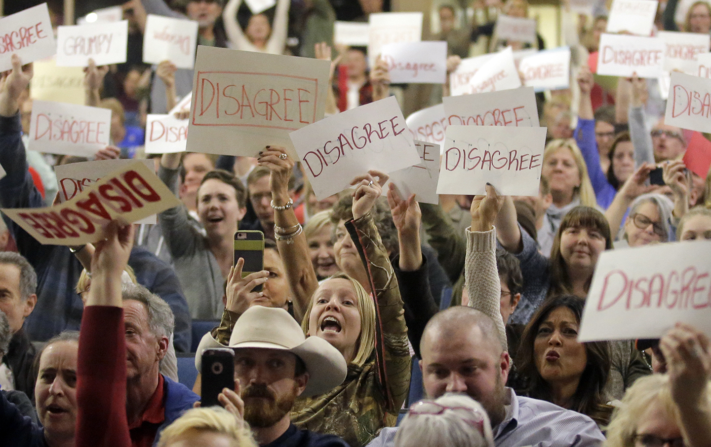 People react as U.S. Rep. Jason Chaffetz speaks during a town hall meeting at Brighton High School in Cottonwood Heights, Utah.