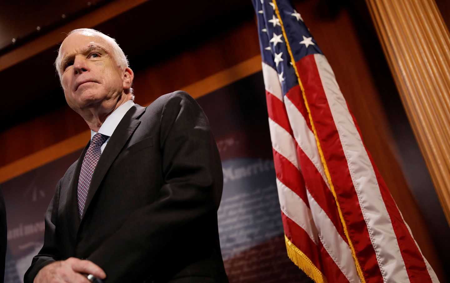 Senator John McCain looks on during a press conference