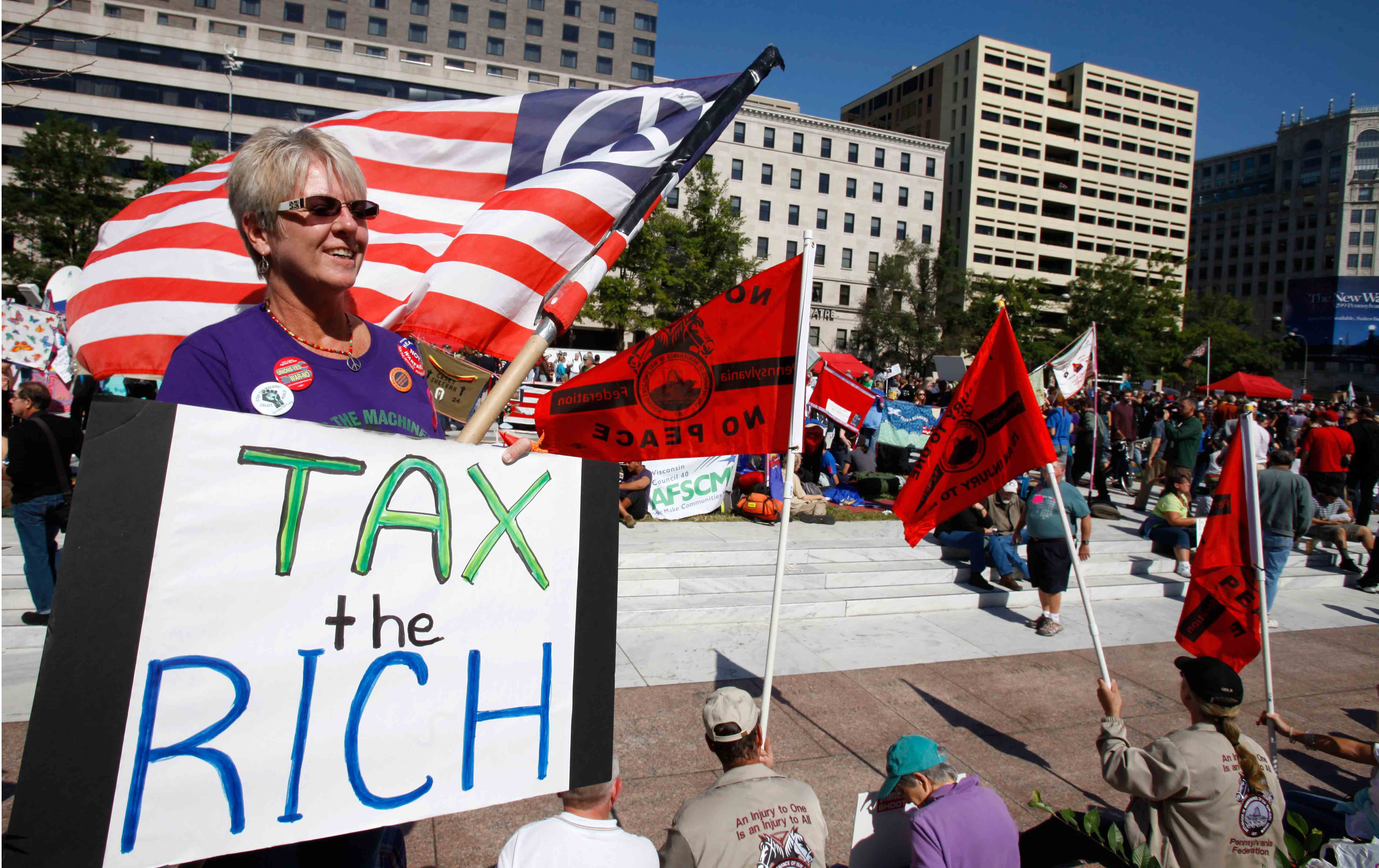 A woman holds a sign saying 