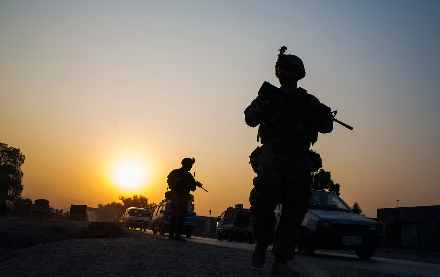 US soldiers walk near a police checkpoint in Afghanistan