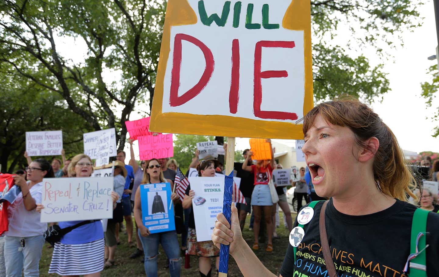 Protesters gather outside a Sen. Ted Cruz town hall meeting, Thursday, July 6, 2017, in Austin, Texas.