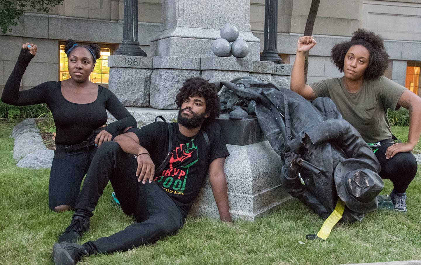 Activists pose after a Confederate statue is toppled in Durham, NC.