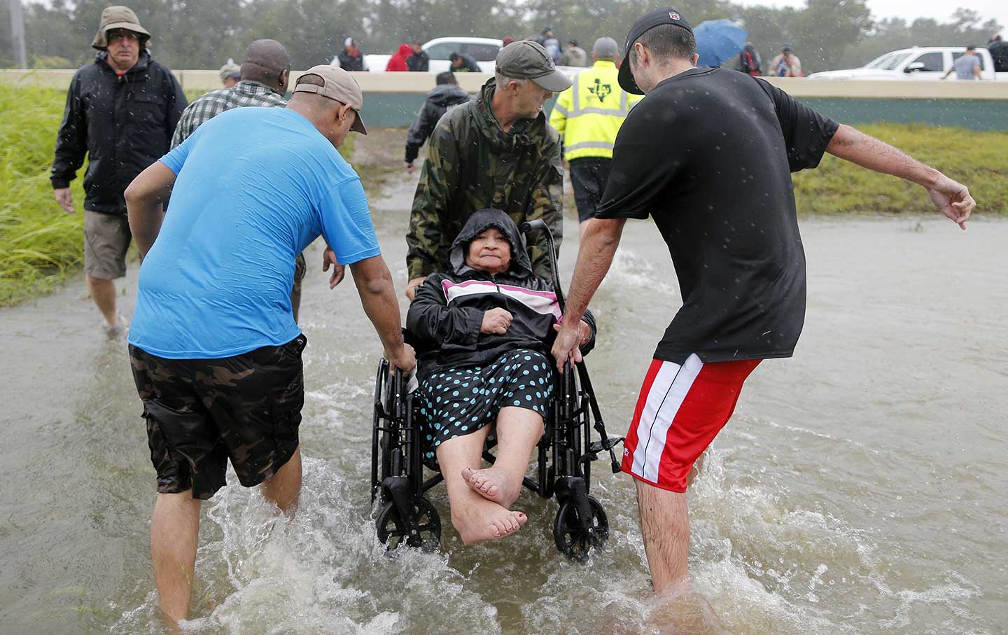An elderly woman in a wheelchair is rescued from the flood waters of tropical storm Harvey in east Houston, Texas, U.S., August 28, 2017.