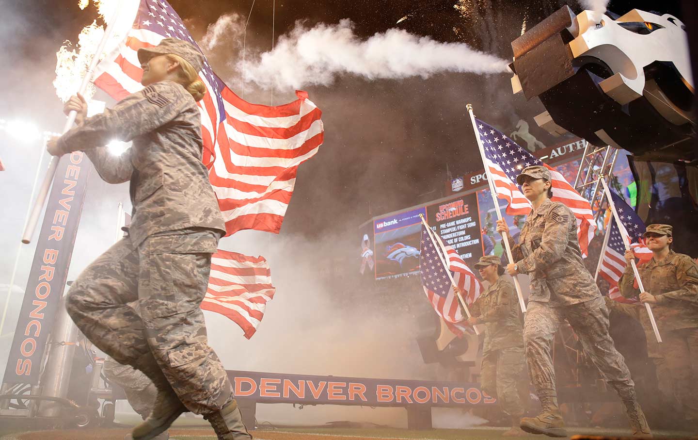Military personnel carry flags