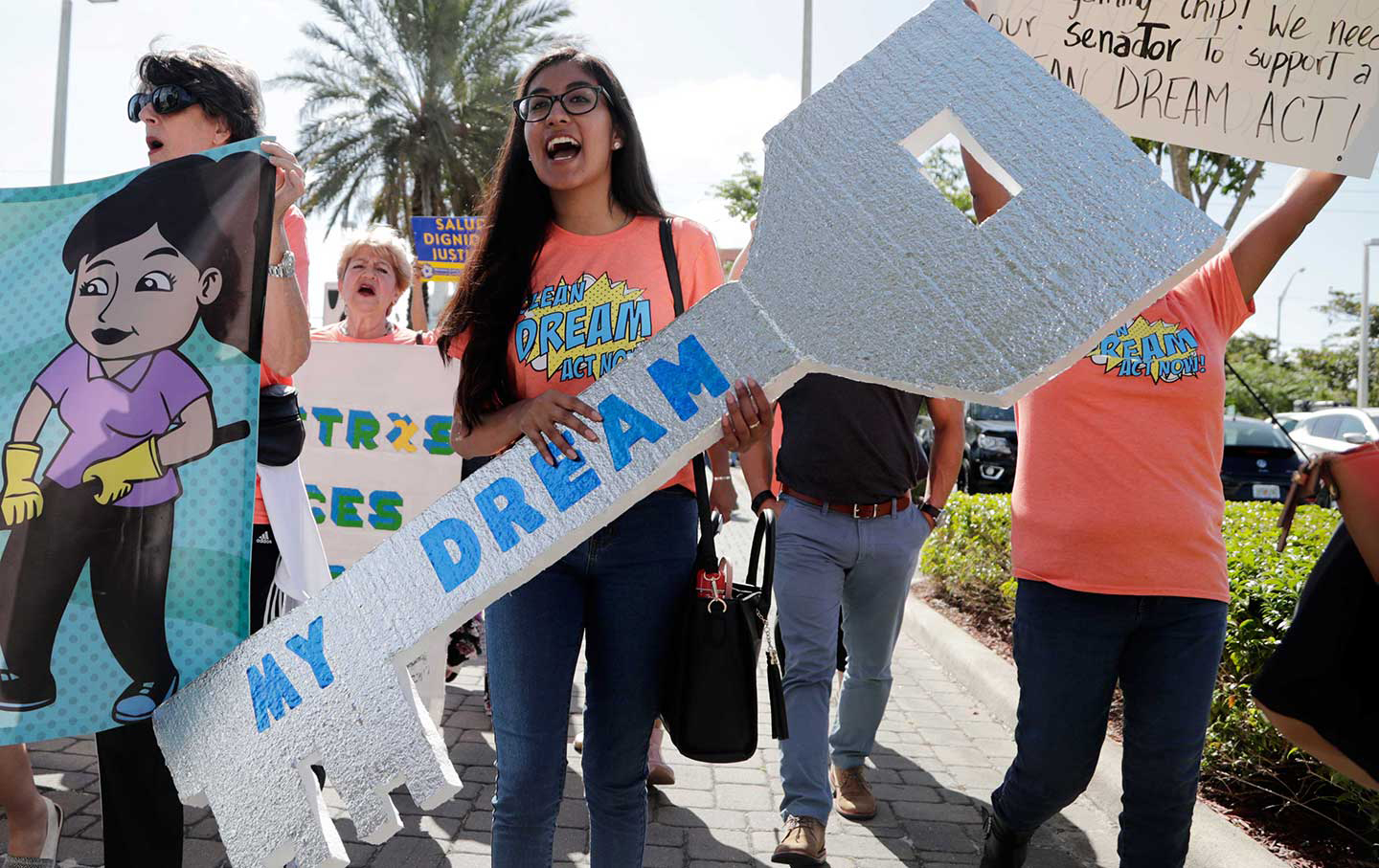 Maria Angelica Ramirez carries a large key reading 