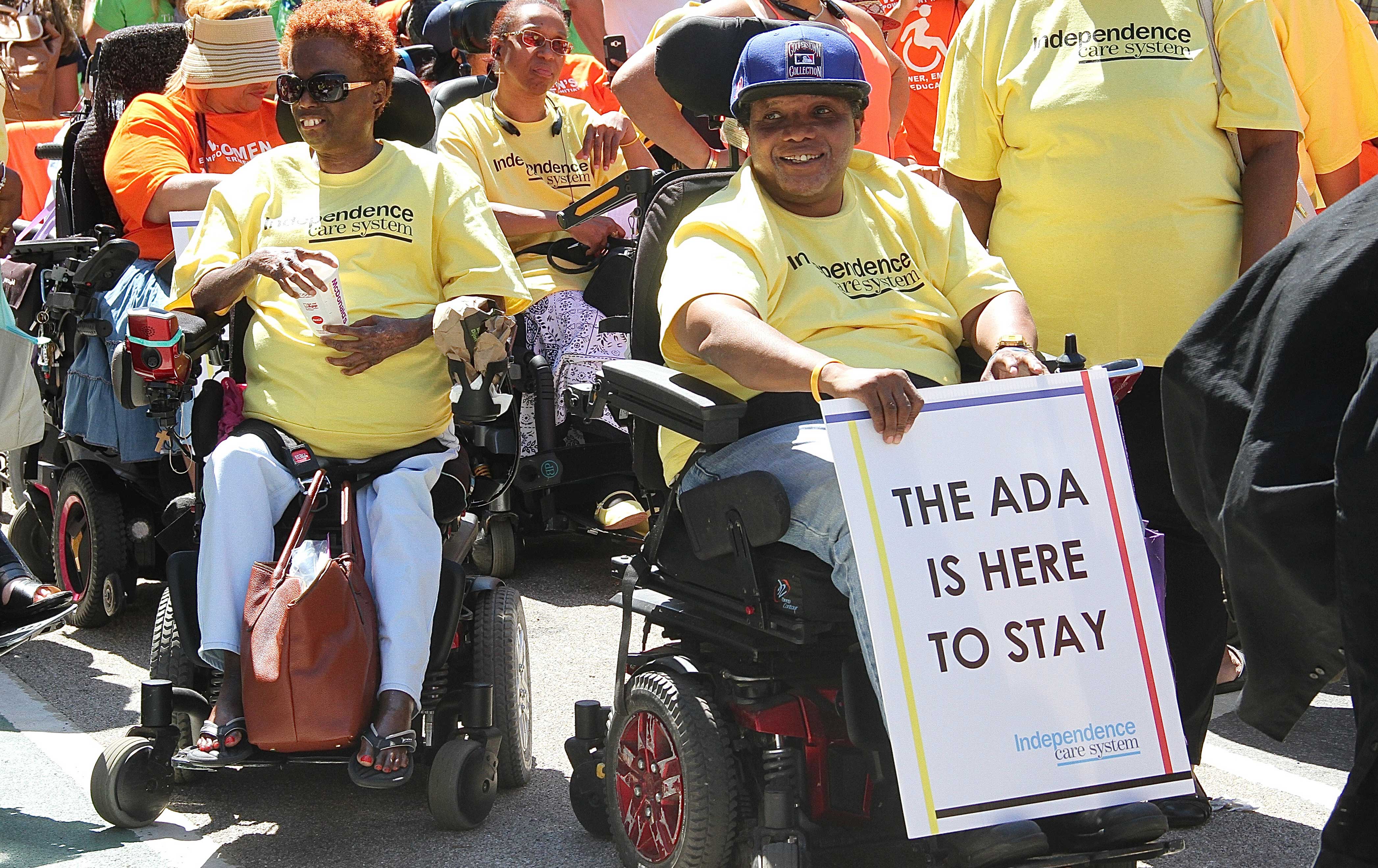 A participant holds a sign saying 