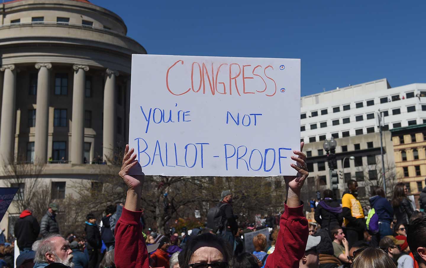 A protester holds up a sign warning Congress during the March for your Lives protest and march for gun control in the United States, held on Pennsylvania Avenue in Washington, DC.