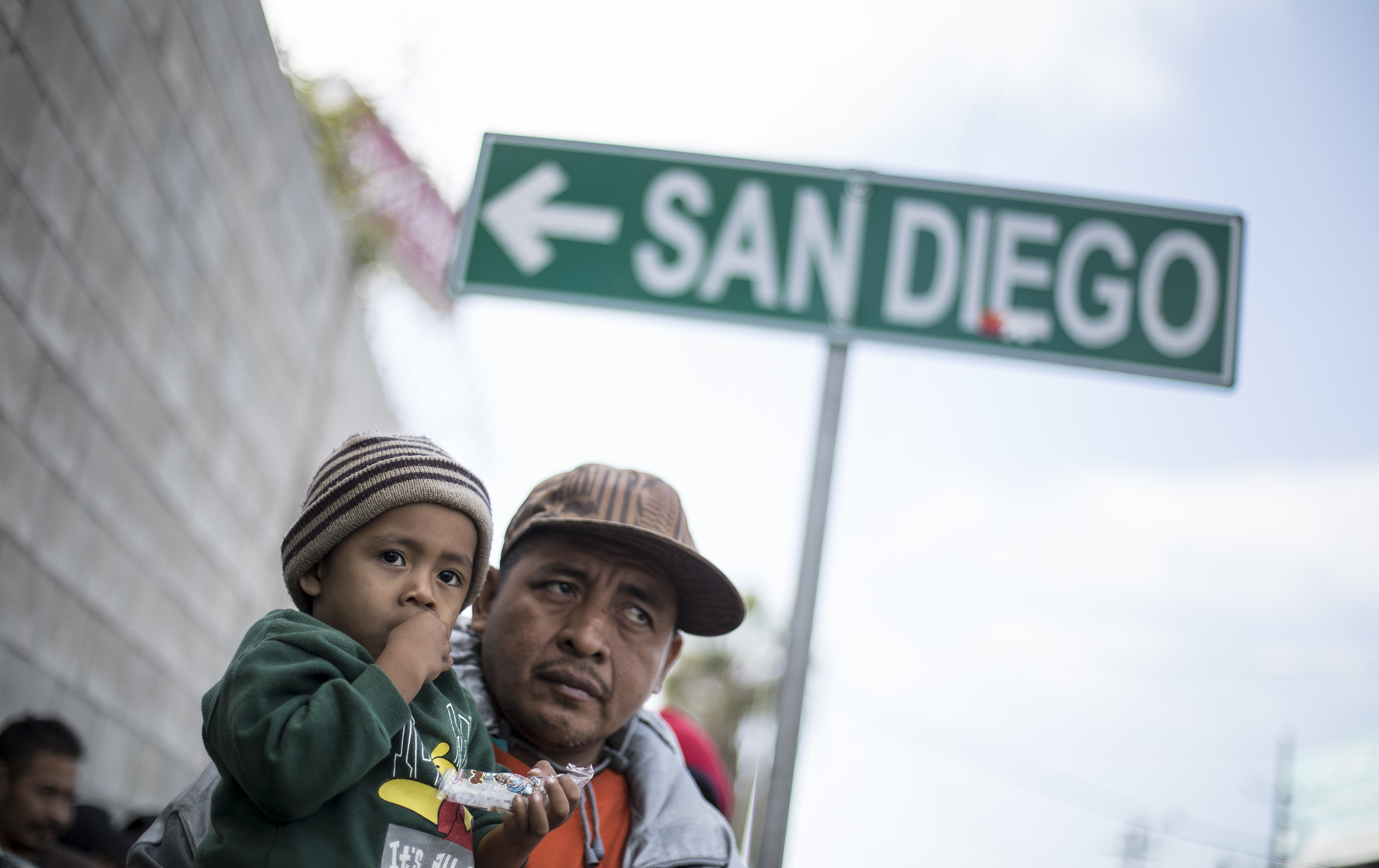 A father and his son await tutorship by immigration lawyers in Tijuana, Mexico, Friday, April 27, 2018.