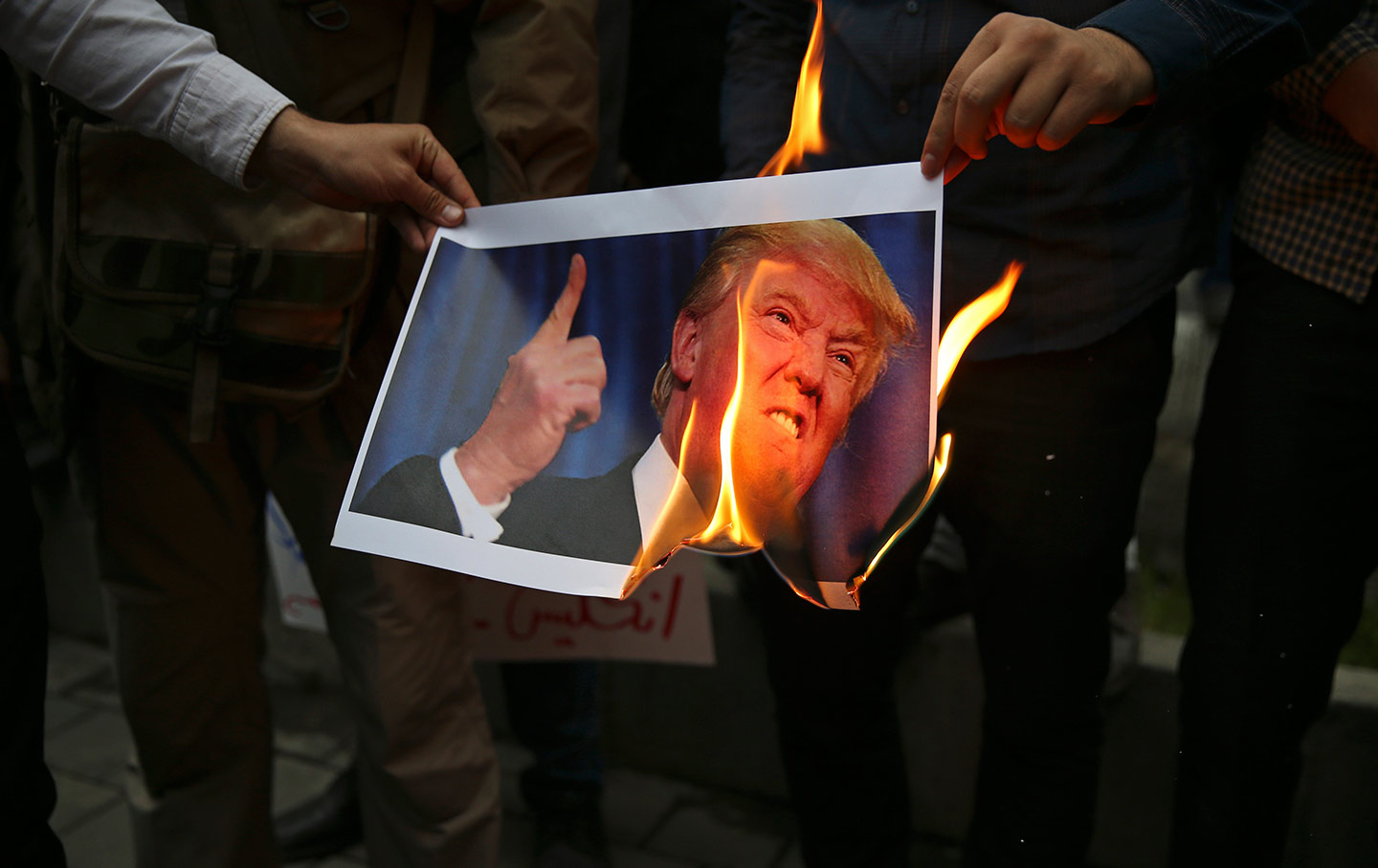 Iranian protesters burn Trump photo