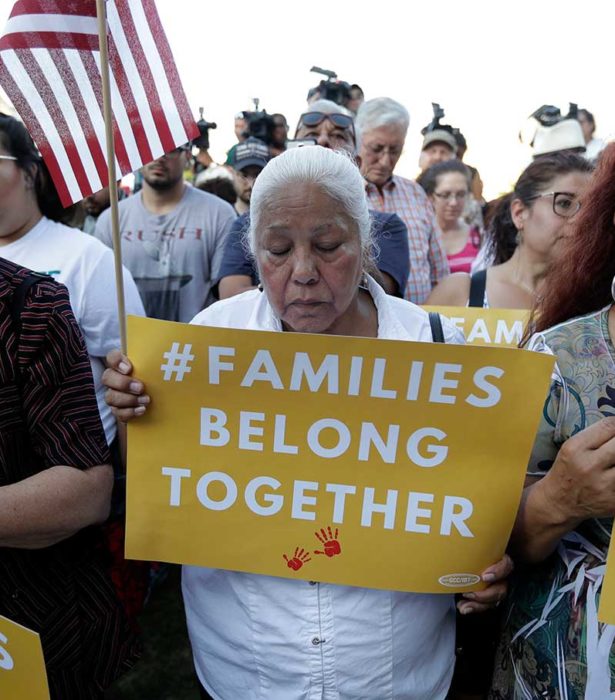 Protesters pray during a Rally For Our Children event to protest a new 