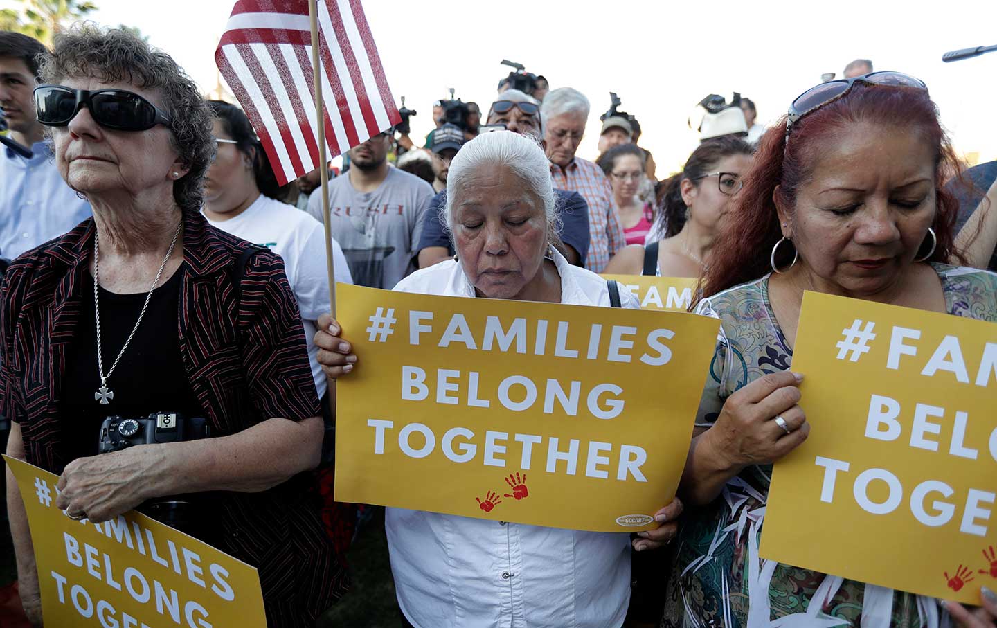 Protesters pray during a Rally For Our Children event to protest a new 