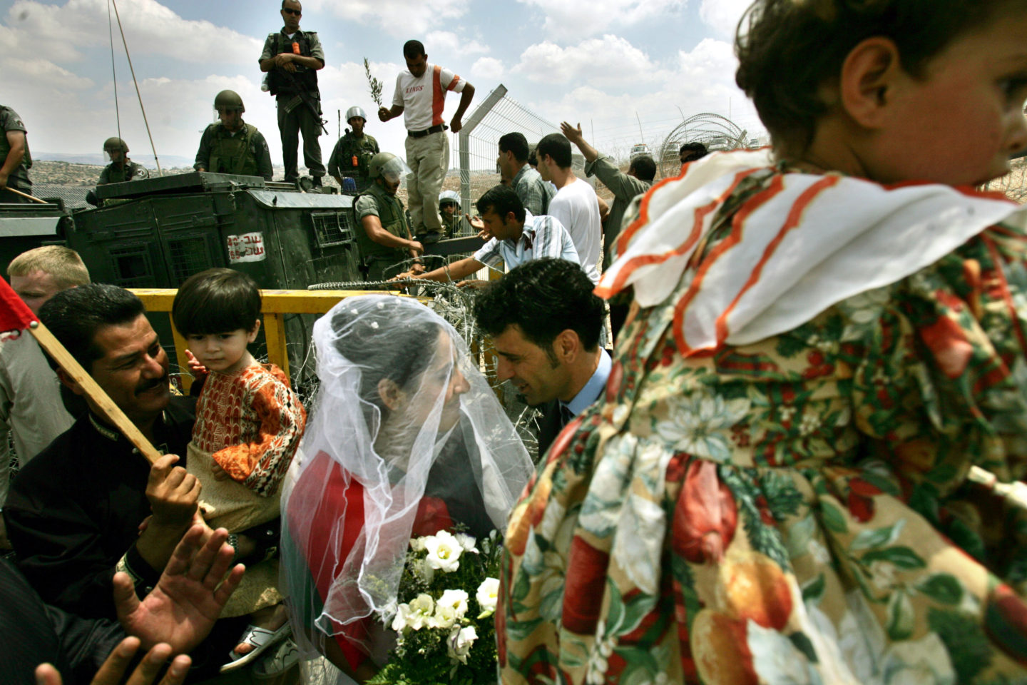 A Palestinian couple celebrates after their wedding ceremony, as part of a protest against Israel's separation wall.