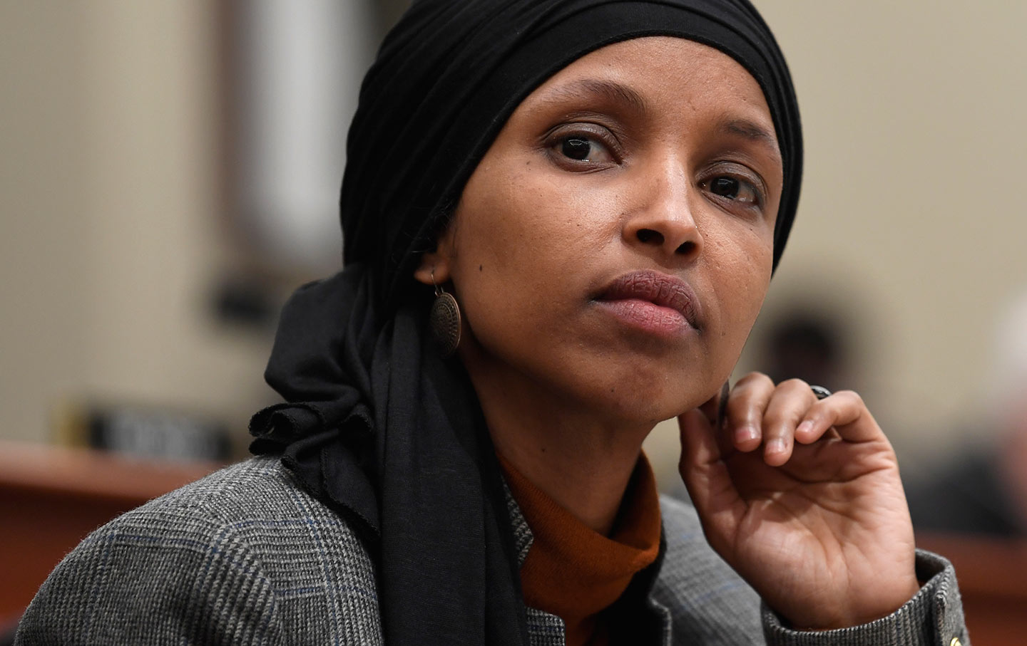 In this March 12, 2019, photo, Rep. Ilhan Omar, D-Minn., listens as Office of Management and Budget Acting Director Russ Vought testifies before the House Budget Committee on Capitol Hill in Washington. Debate in Congress over Israel and anti-Semitism is providing President Donald Trump an opening to appeal to Jewish American voters (AP Photo/Susan Walsh)
