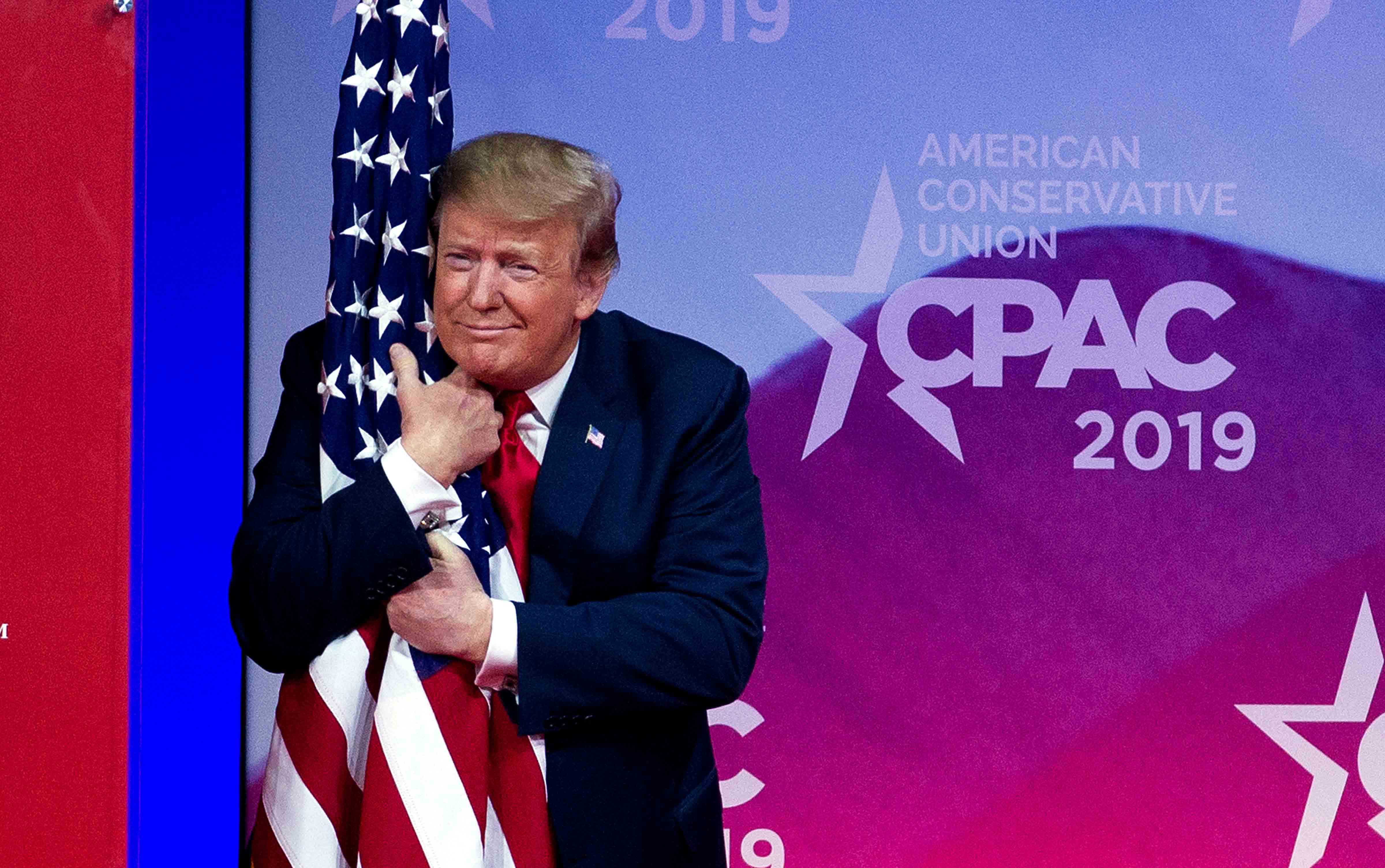 Trump hugs American flag