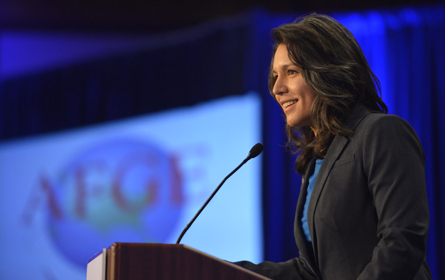 Tulsi Gabbard speaking at podium