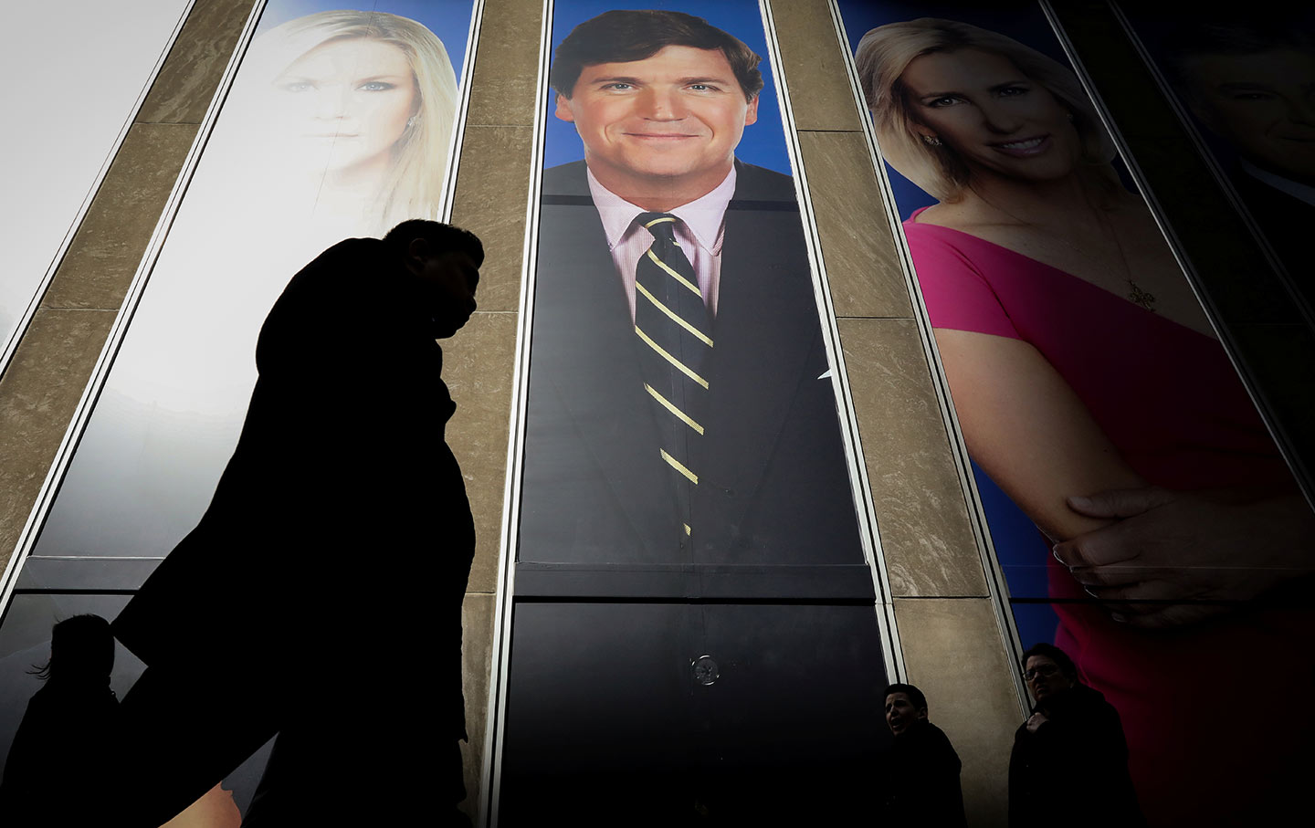 a promo for Fox News hosts including Tucker Carlson on the News Corporation building in New York