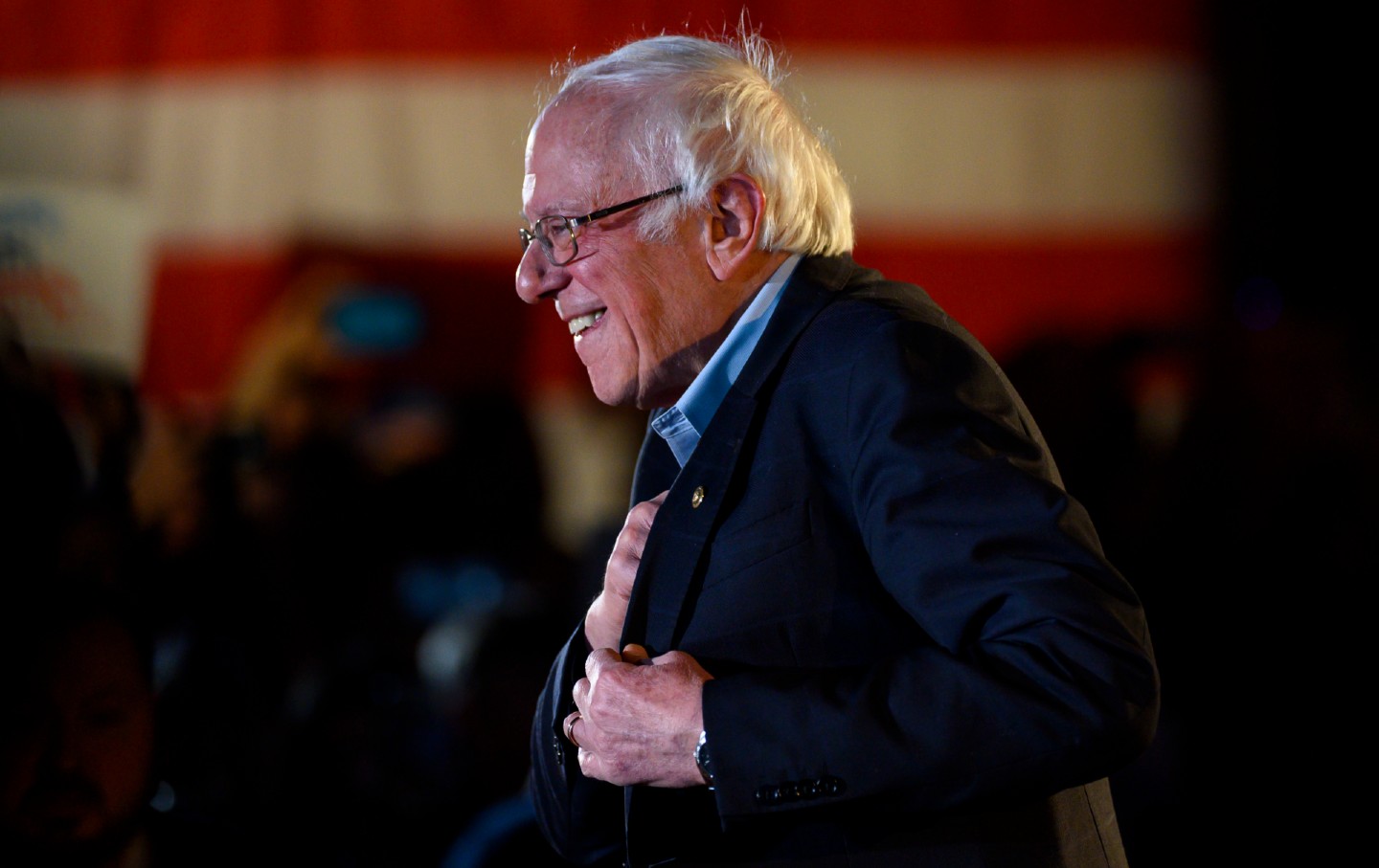 Senator Bernie Sanders smiling as he speaks at a campaign event