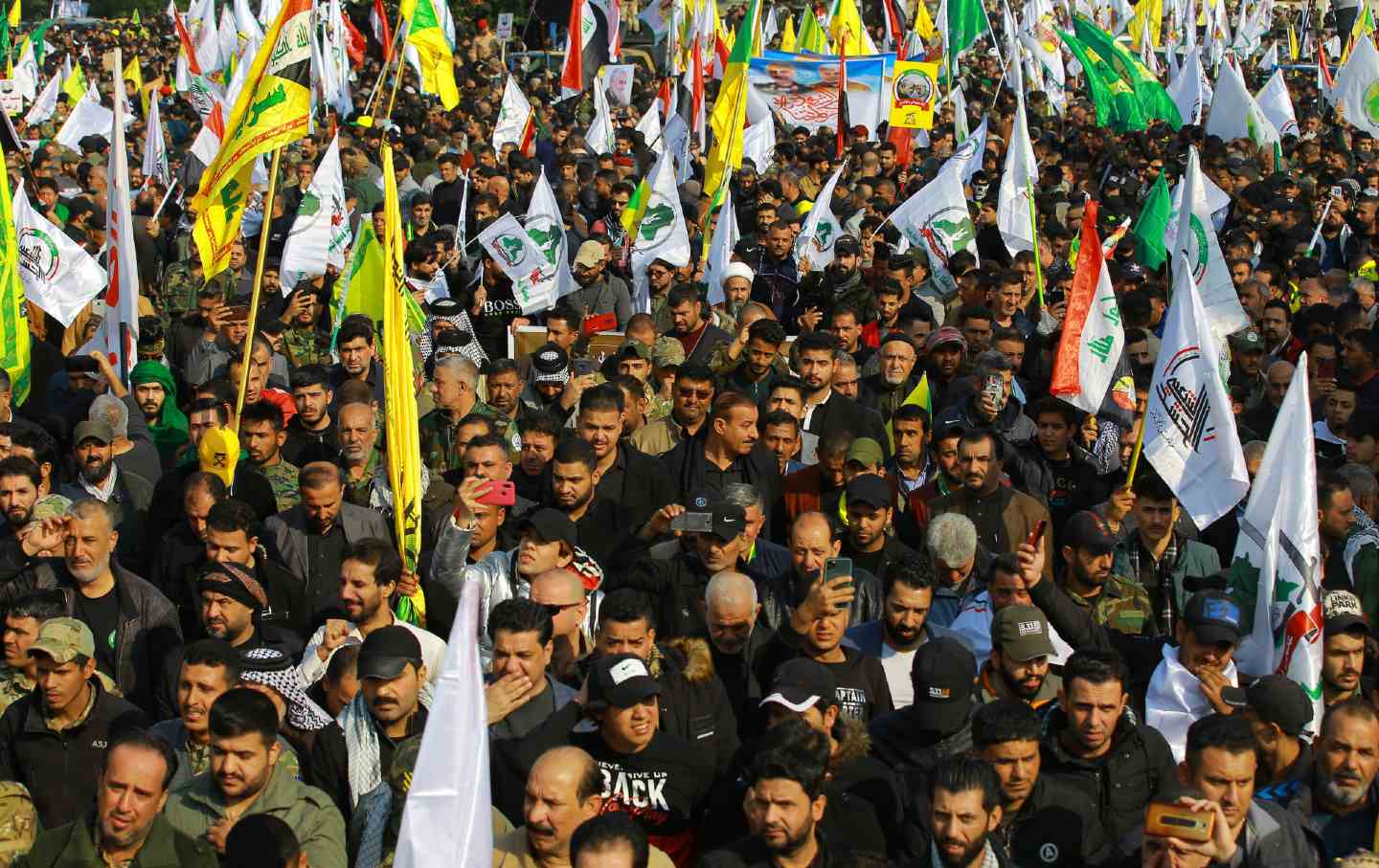 Mourners attend a funeral procession for Suleimani and al-Muhandis.