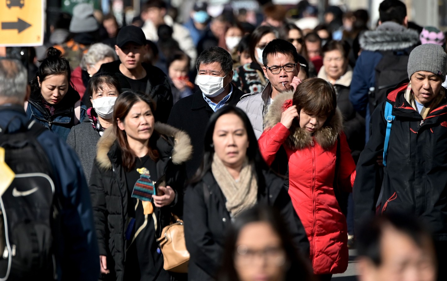 People in surgical masks in Flushing, Queens, New York City.