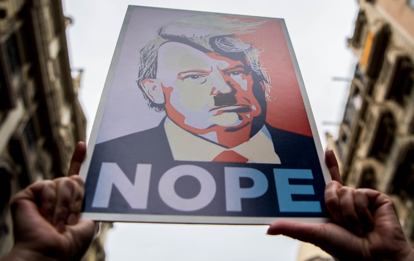 Poster of Trump at a women's march rally that says 