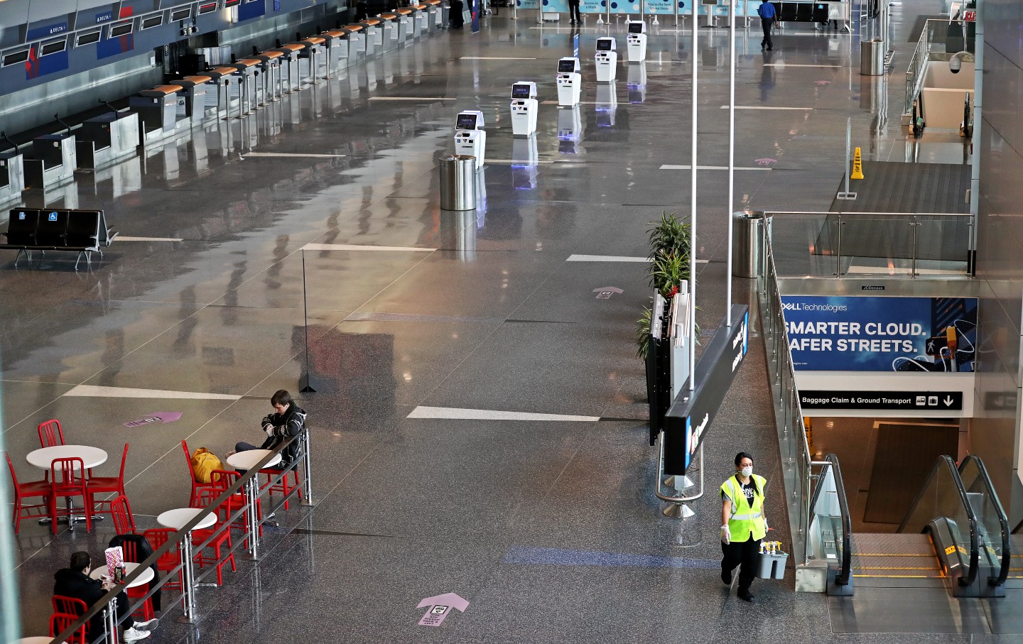 A cleaner walks though Logan airport