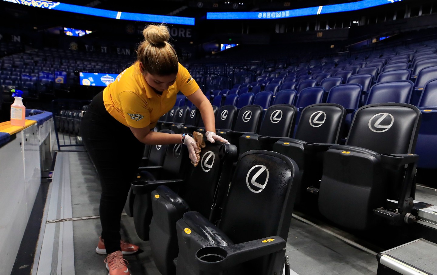 A worker cleans seat after Covid-19 cancellation