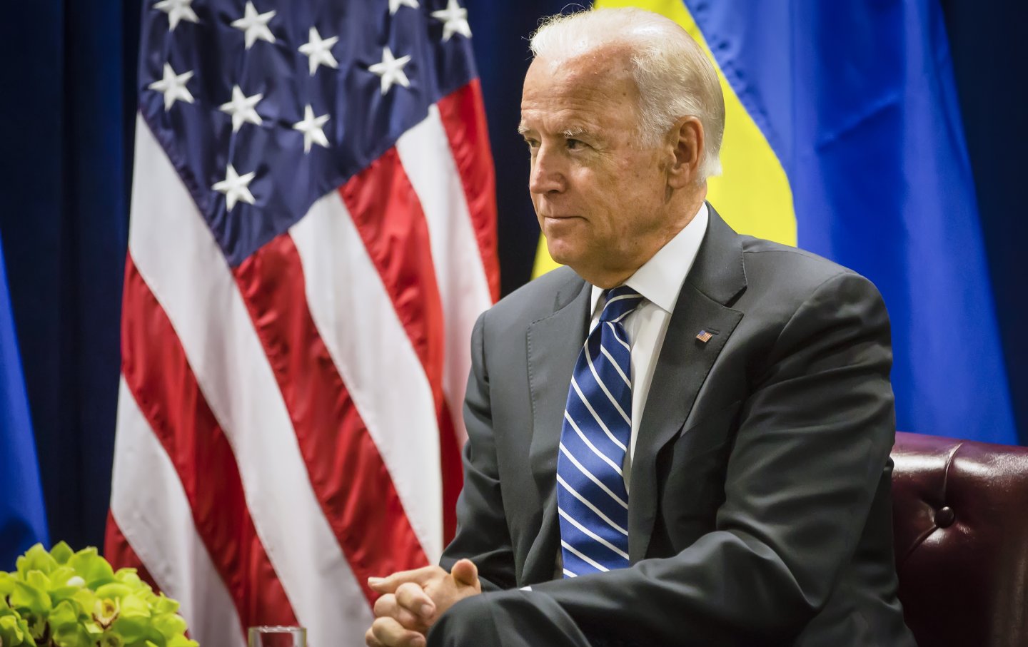 Biden sits in front of a US flag