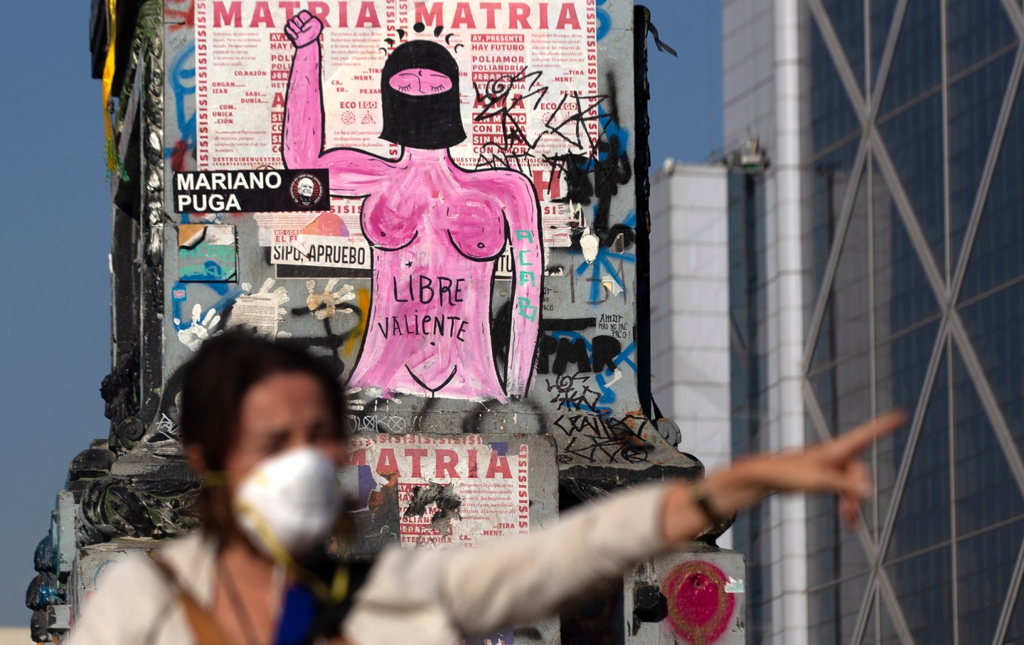 A woman wears a face mask during a protest in Chile