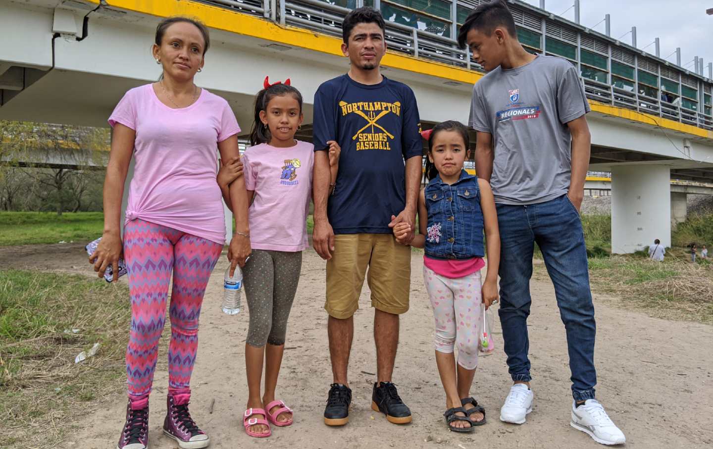 Family of 5 pose for a photograph.