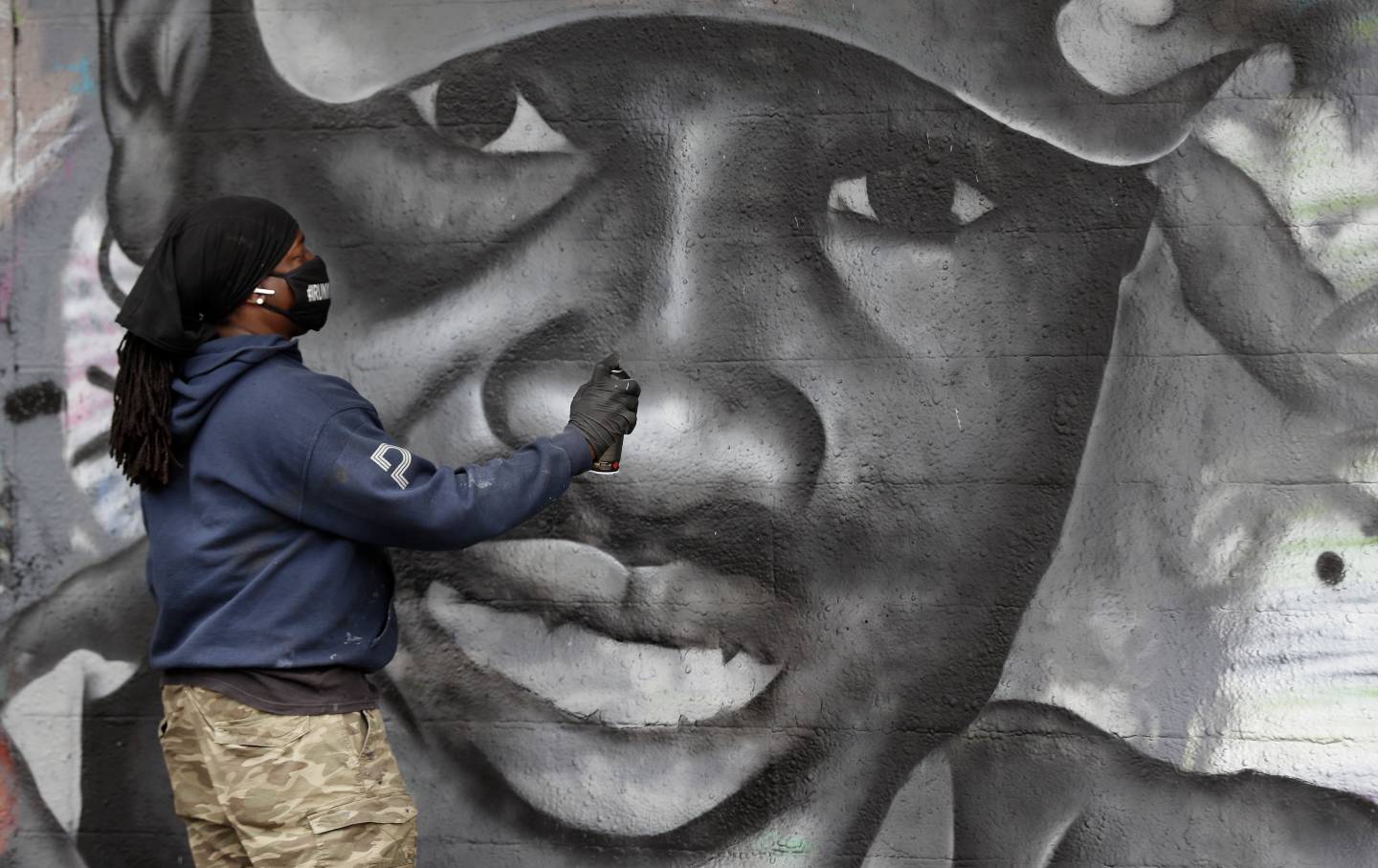 Artist creating a mural of Ahmaud Arbery