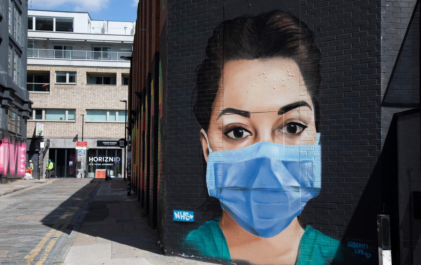 Street mural of a nurse wearing a mask