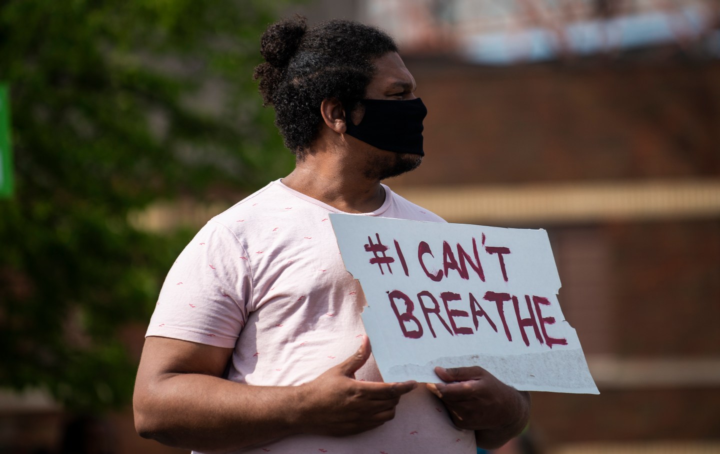 A man holds a sign that says 