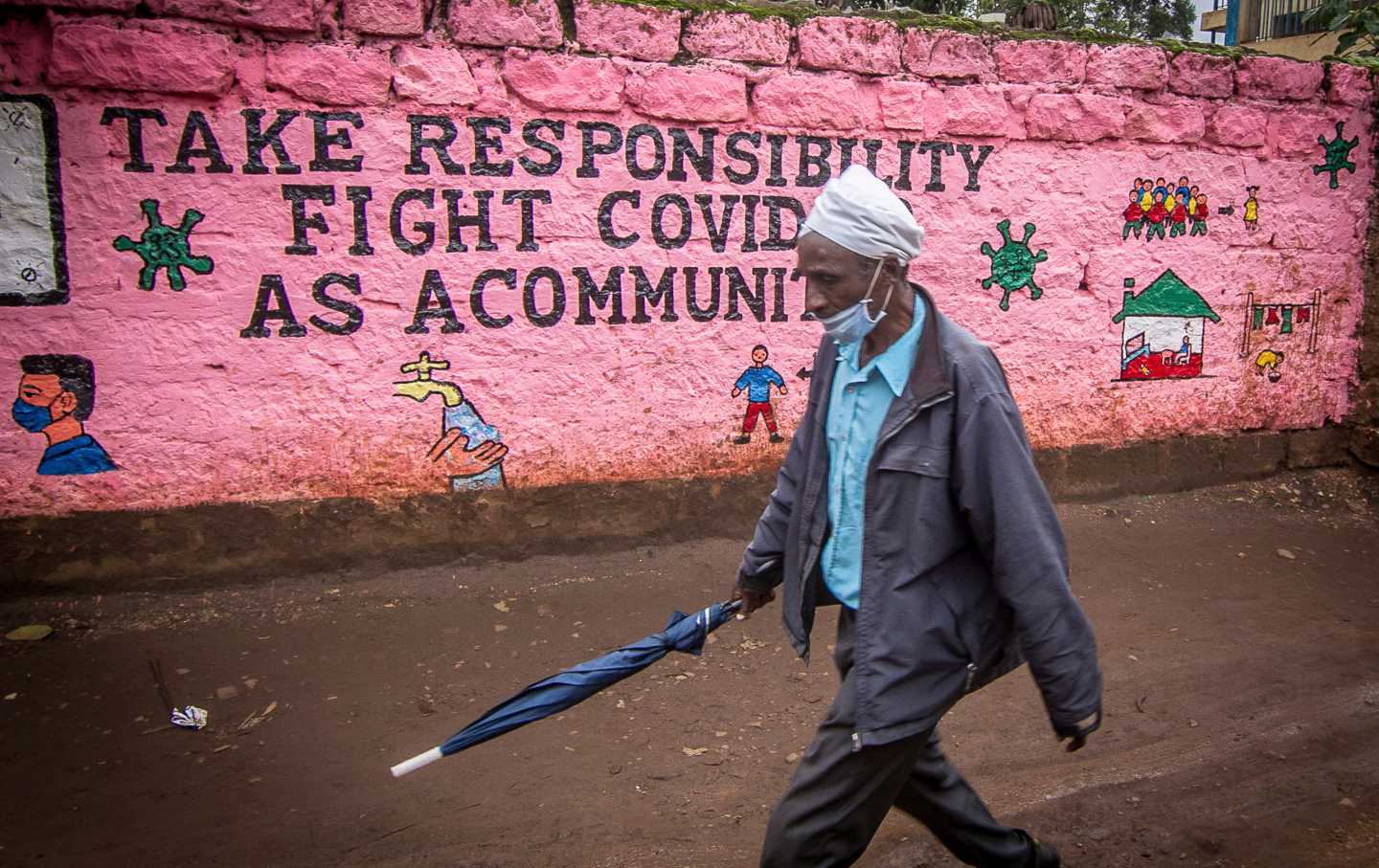 A man walking with a face mask in Kibera, a slum of Nairobi