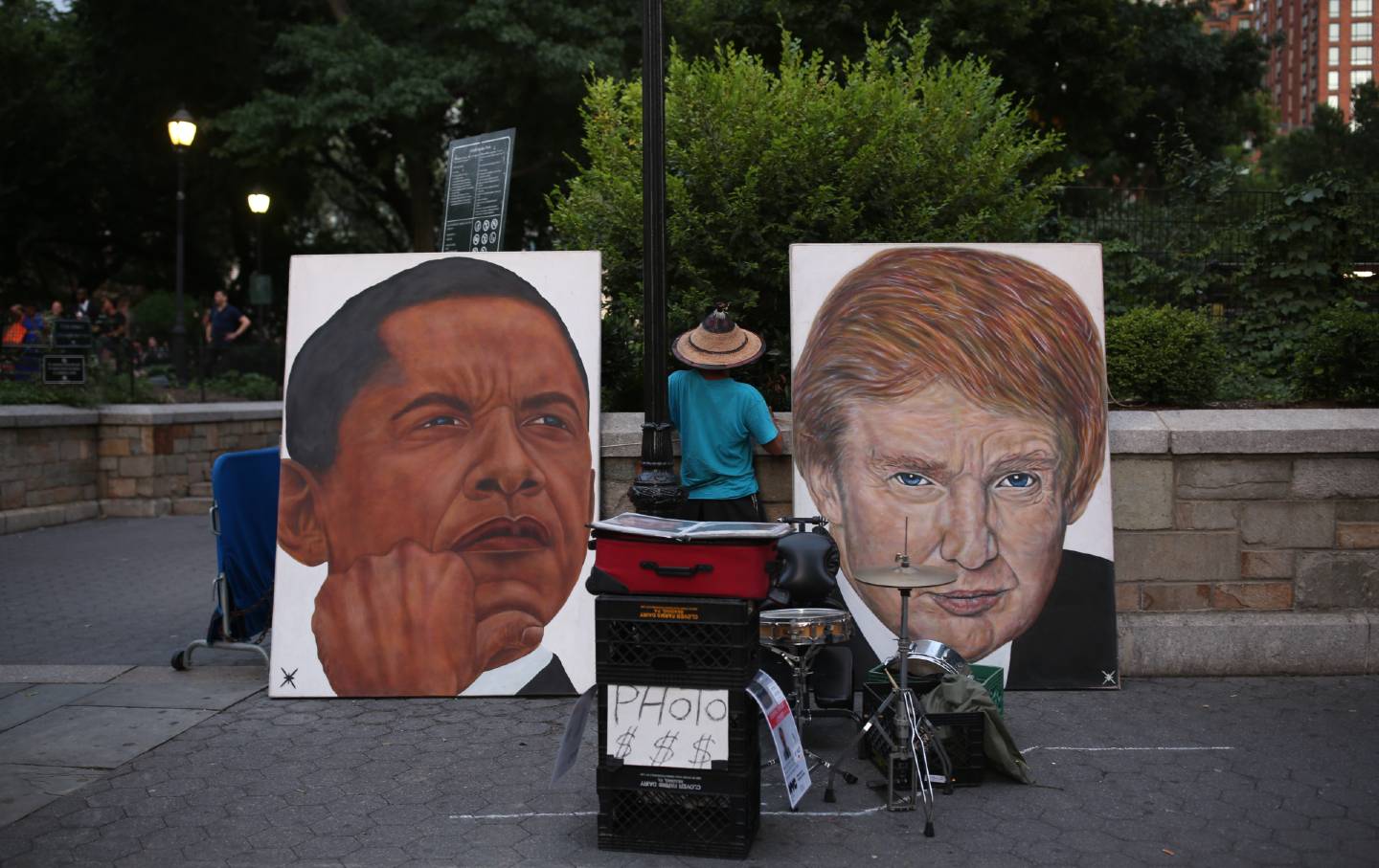 Paintings of Donald Trump and Barack Obama's faces are displayed outside a park in New York CIty