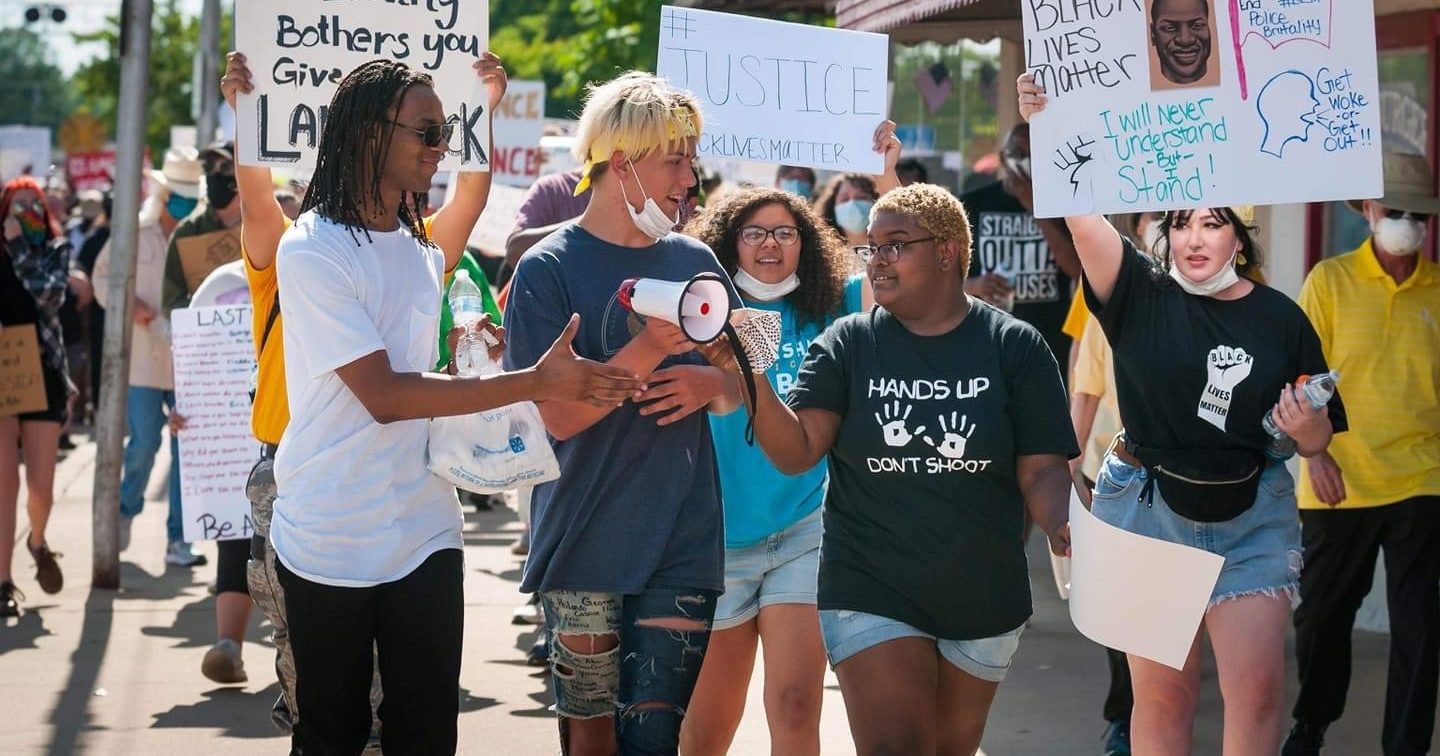 Protesters hold up Black Lives Matter signs