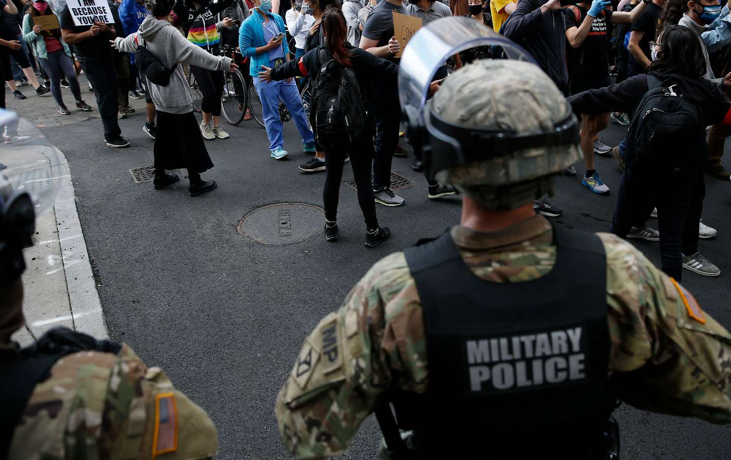 Military police face crowd of marching protesters