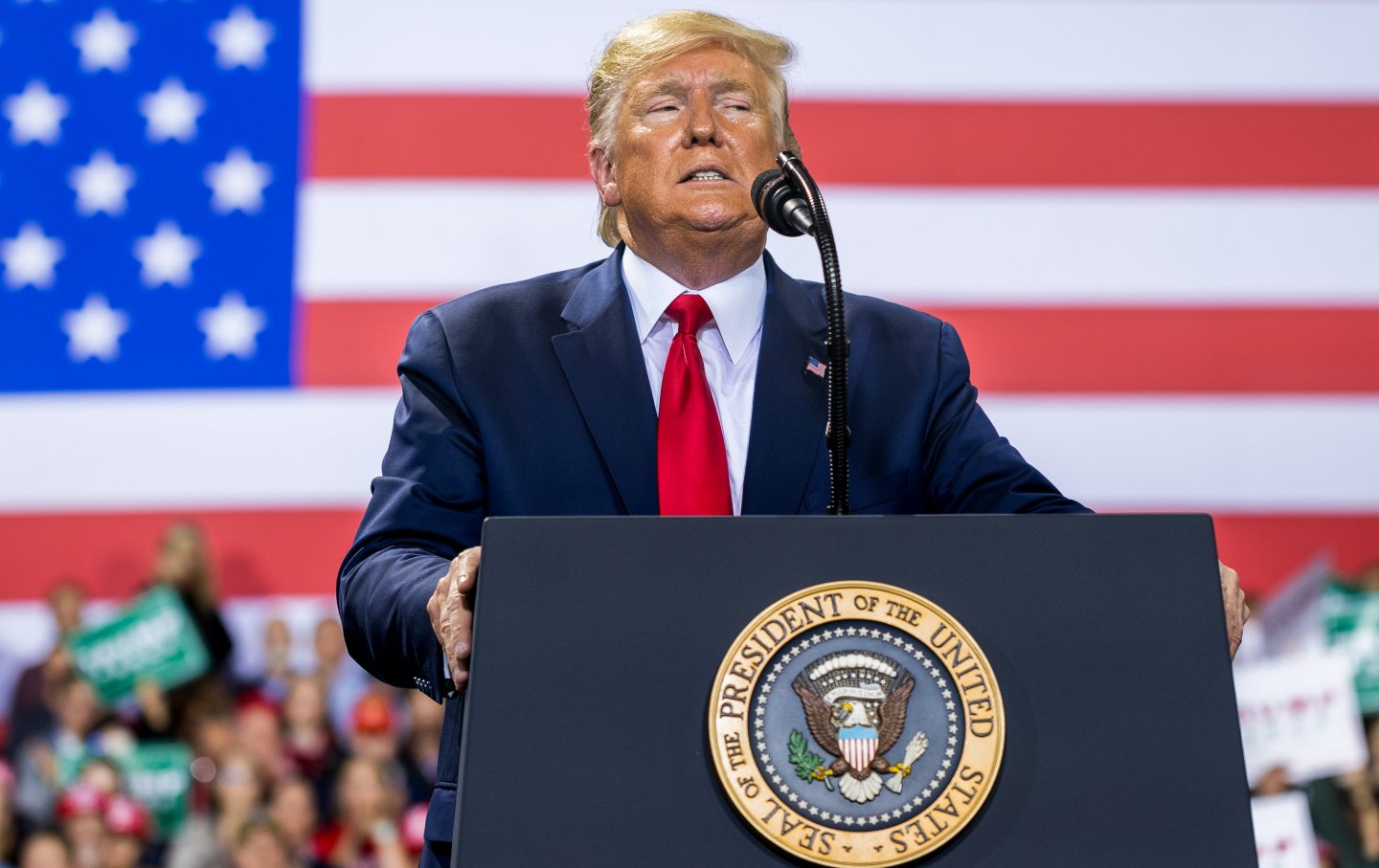 Trump in front of an American flag