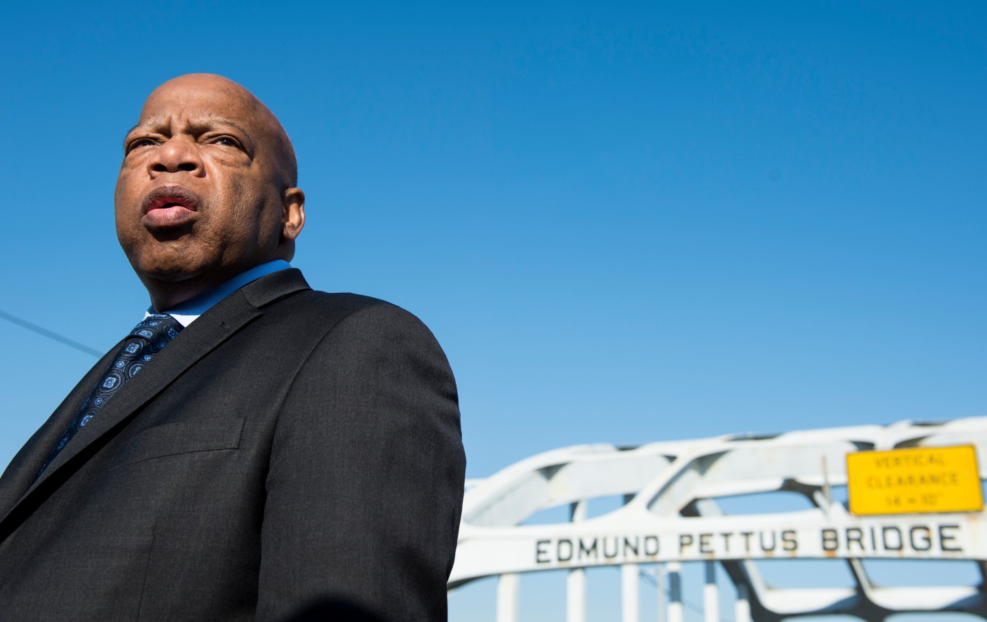 Portrait of John Lewis with Edmund Pettus Bridge in background