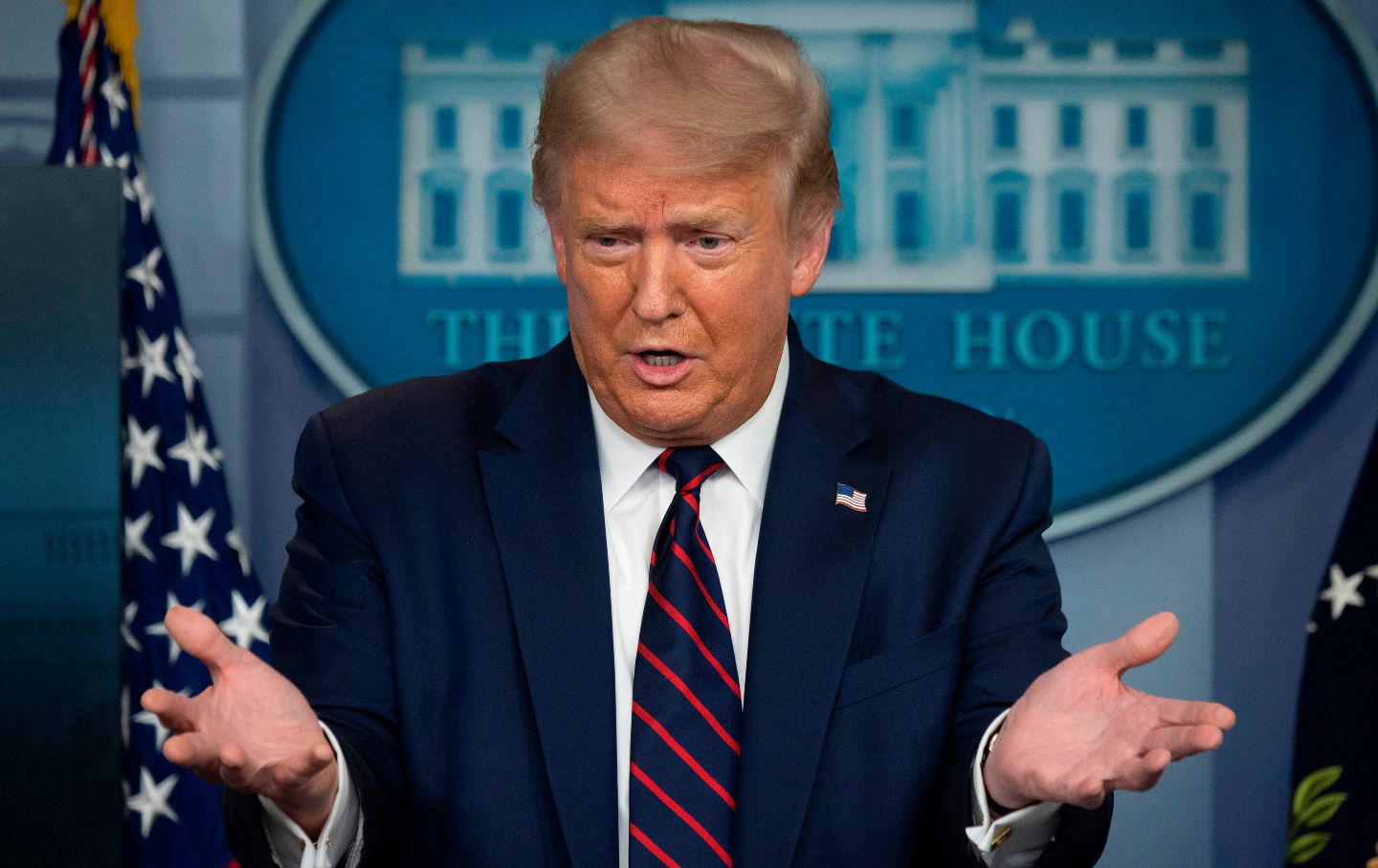 President Trump gestures in front of a lectern