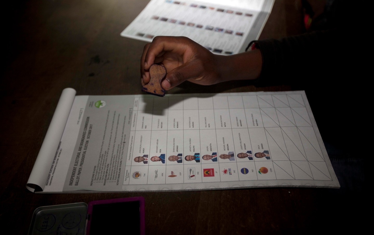 A man stamps a ballot for Kenya's elections