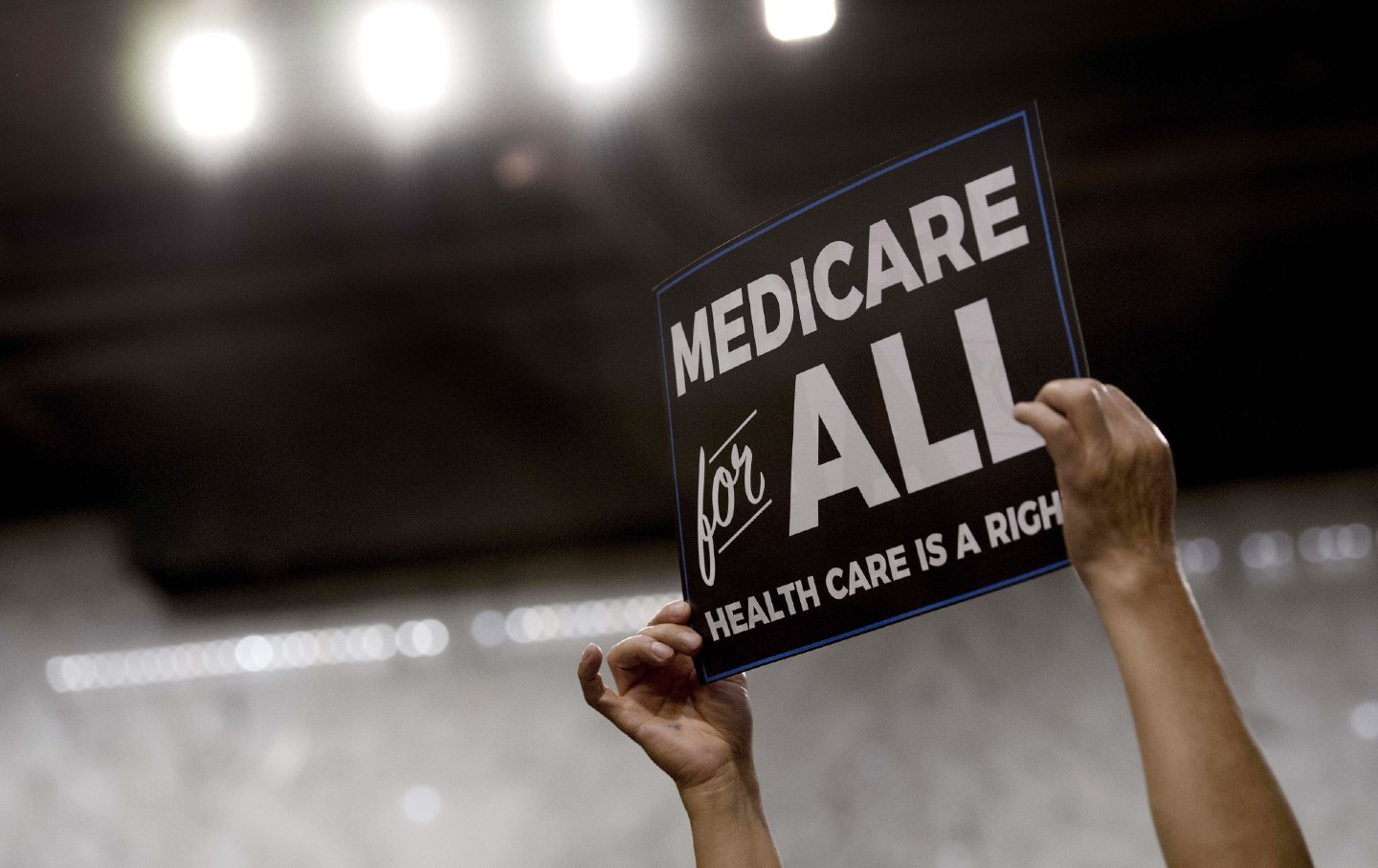 Someone holds up a Medicare for All sign at a rally for former candidate Bernie Sanders.