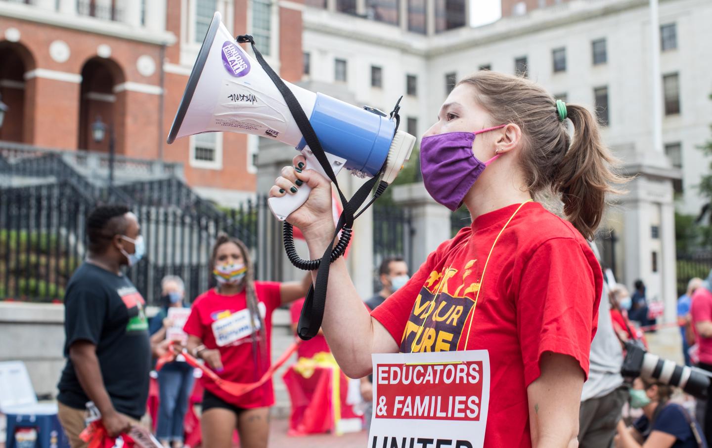 Woman holding a megaphone leads protesters