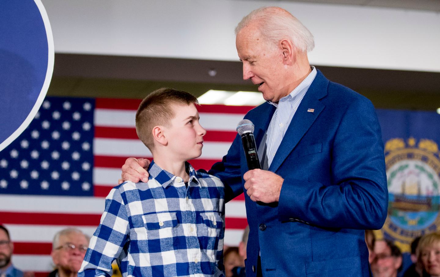 12 year-old Brayden Harrington stands on stage with Joe Biden at a campaign rally