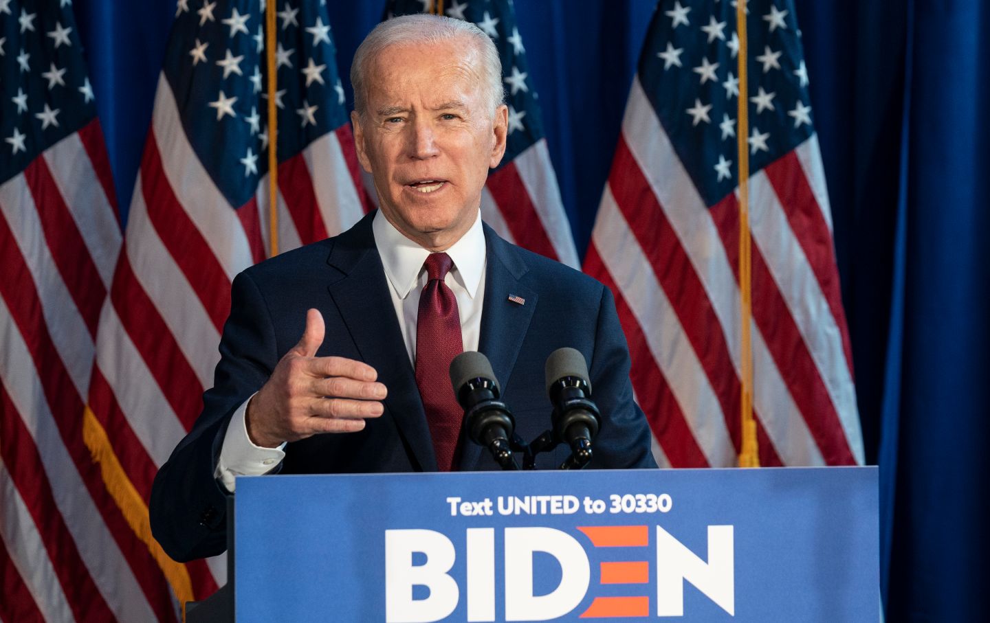 Joe Biden speaking in front of a lectern