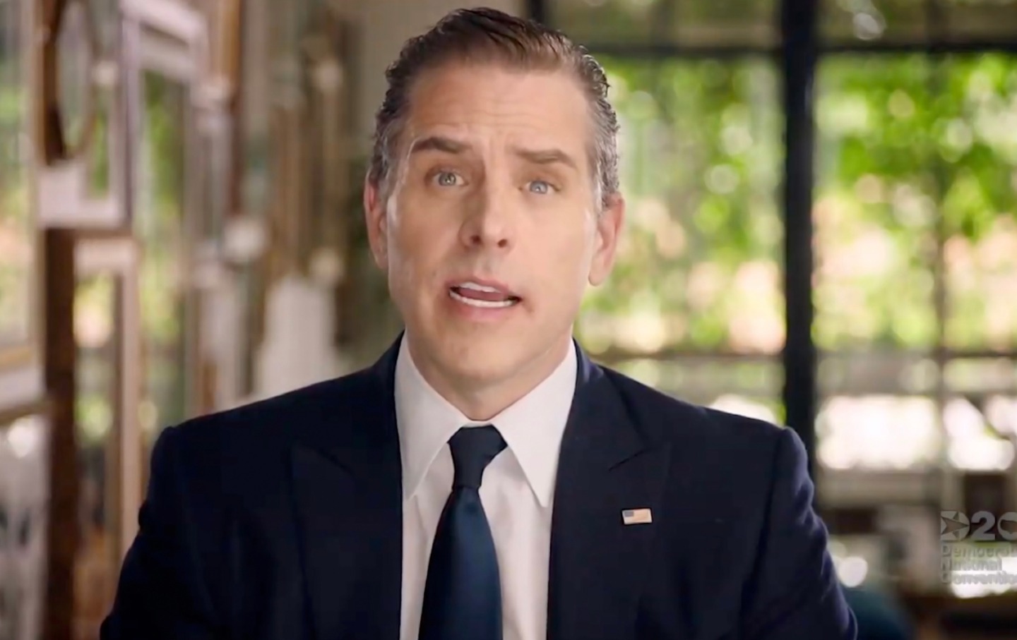 Hunter Biden, wearing a suit and tie, speaks at the DNC via webcam