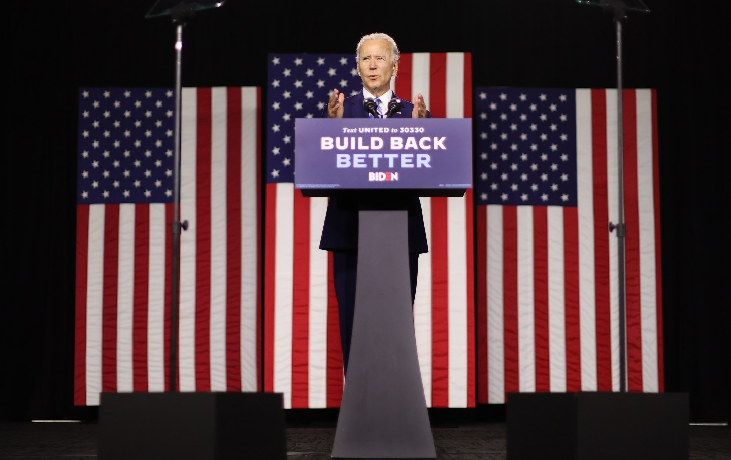 Joe Biden speaks at a podium that reads 
